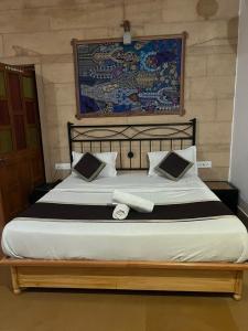 una camera da letto con un grande letto con lenzuola bianche e nere di hostel Wyra home stay Jaisalmer a Jaisalmer