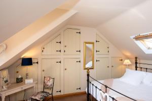a attic bedroom with a bed and a skylight at The Borrowers in Elston