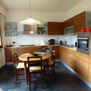 a kitchen with a wooden table and chairs in it at Girasoli in Pisa