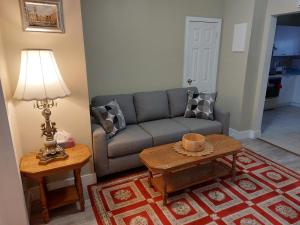 uma sala de estar com um sofá e uma mesa em Appartement Cartier em Longueuil