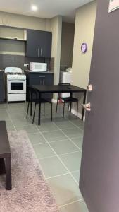 a kitchen with a table and a stove top oven at Cozy 1-bedroom apartment in Frequente, St. George 