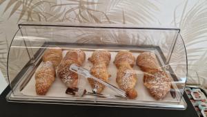 a glass container filled with pastries on a table at POETICA BOUTIQUE SKY HOTEL in Naples