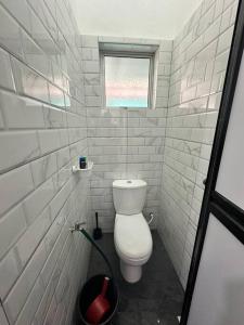 niewielka łazienka z toaletą i oknem w obiekcie One Mama’s Guest House w mieście Kuala Selangor