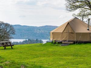 a large tent in a field with a picnic table at YHA Windermere in Troutbeck