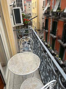 a table and chairs sitting on a balcony at B&B La Canzonetta in Naples