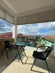 a balcony with a table and two chairs and a view at YK Sweet home sungai petani 1 @ 16 people above in Sungai Petani