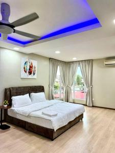 a bedroom with a bed with a ceiling fan at YK Sweet home sungai petani 1 @ 16 people above in Sungai Petani