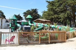 - un toboggan aquatique dans un parc avec une aire de jeux dans l'établissement Camping Les Maraises, à Saint-Martin-de-Ré