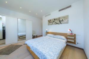 a bedroom with a bed and a glass wall at Villa Amarador in Santanyi +22 photos