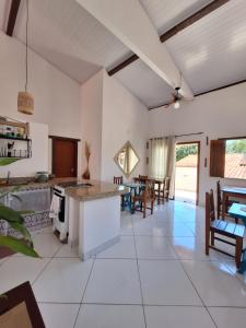 a kitchen and living room with a table and chairs at D'Ajuda Inn in Arraial d'Ajuda