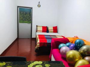 a room with a bed with balloons on the floor at Bole Guest Bentota in Bentota