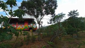 a colorful train on the tracks in a field at Los Nopales Glamping in Sáchica