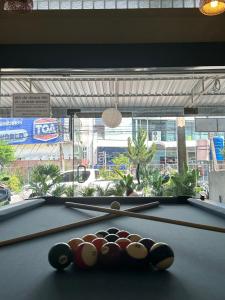 a pool table with two cue balls on it at Tangerine Dream Guesthouse in Koh Phangan