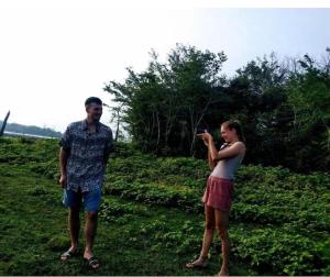 a man and a woman standing in a field at River Edge Safari House in Udawalawe