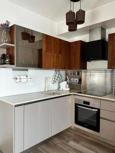 a kitchen with white cabinets and stainless steel appliances at Sweet Home in Milano smart district in Milan