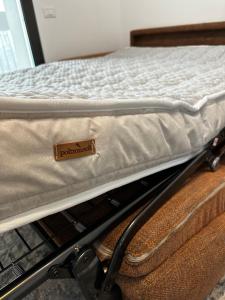 a mattress sitting on top of a metal bed cart at Sweet Home in Milano smart district in Milan