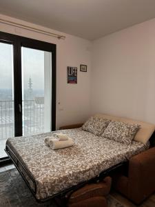 a bedroom with a bed with two towels on it at Sweet Home in Milano smart district in Milan
