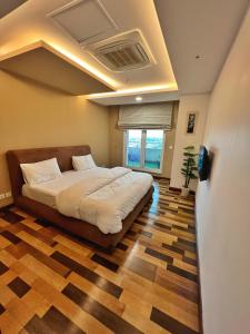 Two bedroom suite, Gold crest Mall في لاهور: غرفة نوم فيها سرير وتلفزيون