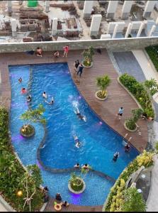 a swimming pool in a building with people in it at COMFORTSTAY @Citra Plaza Nagoya #32-08 ( Sea View ) in Jodoh