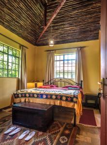 a bedroom with a bed with a wooden ceiling at The Jungle Oasis with heated pool in Nairobi