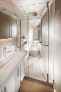 a bathroom with two sinks and a shower at House of Architects in Vals