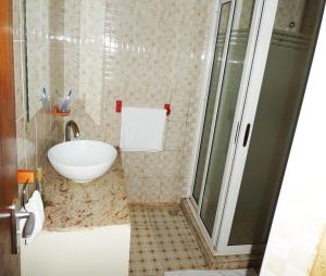 La salle de bains est pourvue d'un lavabo et d'une douche. dans l'établissement Acaki Lodge, à Kitgum
