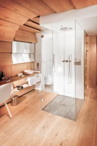 a bathroom with a glass shower with a toilet at House of Architects in Vals