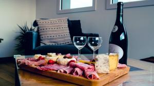 - une table avec un plateau de fromage et des verres à vin dans l'établissement La Char'Vigne, à Anglefort