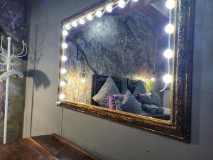 a mirror on the wall of a room with pillows at Suikerbosrant Sleep and go in Pretoria