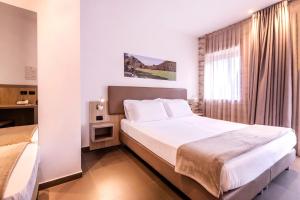 Postel nebo postele na pokoji v ubytování San Giorgio Palace Hotel Ragusa Ibla