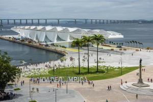 a group of people walking on a beach near the water at studio in Rio de Janeiro