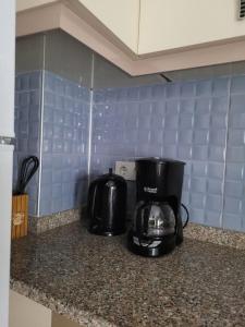 a kitchen counter with a coffee maker and a toaster at Deniz Manzaralı Müstakil ev Aybalik in Ayvalık