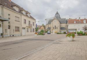 an empty street in a town with a church at Chaource in Chaource
