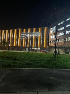 a large building with a sign on it at night at Sweet Home in Milano smart district in Milan