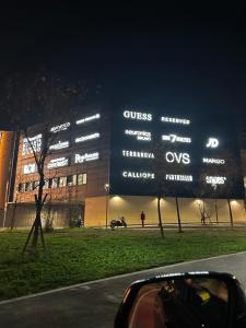 a large sign in front of a building at night at Sweet Home in Milano smart district in Milan
