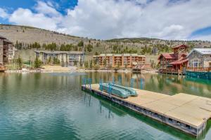a small boat sitting on a dock in a lake at Village Square in Copper Mountain