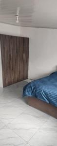 a bedroom with a bed and wooden cabinets at Salama Guest House in Lusaka