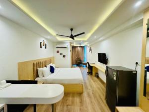 a hotel room with a bed and a desk at The Grand Anukampa Inn Pink City in Jaipur