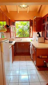 a kitchen with a sink and a window in it at Maison de 3 chambres avec jardin clos et wifi a Anse Bertrand in Anse-Bertrand