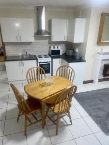 a kitchen with a wooden table and four chairs at Beautiful 3-Bed Bungalow in Bawtry Doncaster in Doncaster