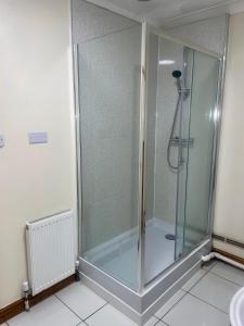 a shower with a glass door in a bathroom at Beautiful 3-Bed Bungalow in Bawtry Doncaster in Doncaster
