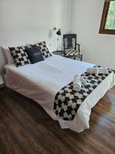 a bed with a checkered blanket on top of it at Hotel Masai Mara Resort Gran Canaria in San Bartolomé