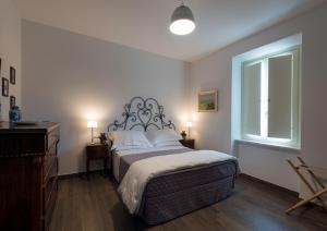 a bedroom with a large bed and a window at Il Cardo in Spinetoli