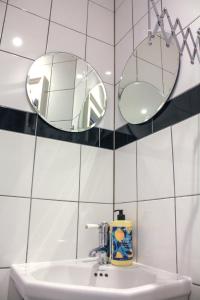 a bathroom with two mirrors and a sink at Joseph's Loft in York