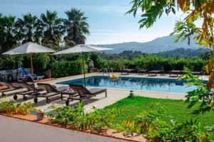a swimming pool with lounge chairs and umbrellas at Quinta Verde Sintra - Casa de Campo in Sintra