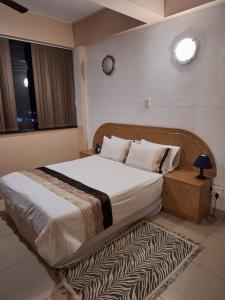 a bedroom with a large bed with a rug at Polela Cottage in Margate