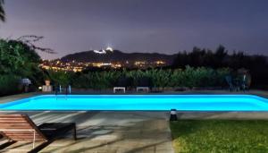a swimming pool with a view of a city at night at Quinta Verde Sintra - Casa de Campo in Sintra