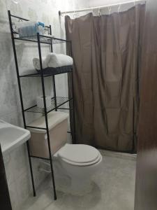 a bathroom with a toilet and a shower at Apartamento a unos pasos de la playa in Cartagena de Indias +37 photos