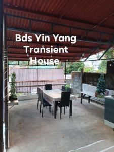 a patio with a table and chairs under a roof at BDS Yin Yang Transient House in Baguio
