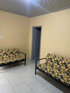 two couches sitting in a room with at Apto 1 ótimo local próximo shopping in Campo Grande